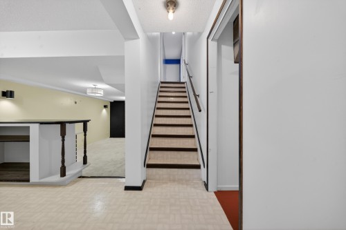 Finished lower level featuring a built-in bar, recessed lighting, wall sconces, and a semi-flush mount ceiling fixture - 1767 61 Street, Edmonton, AB - Indoor Photo Showing Other Room