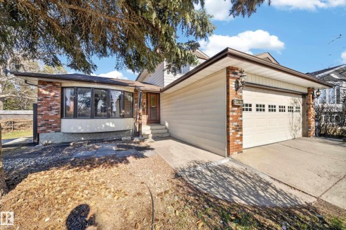 Brick and siding exterior featuring a two-car garage with transom windows - 1767 61 Street, Edmonton, AB - Outdoor