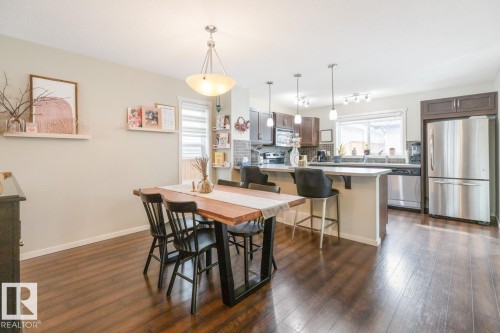 Spacious dining area featuring wood-finish flooring - 5127 1A Avenue, Edmonton, AB - Indoor