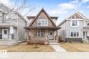 Craftsman-style exterior featuring a covered porch, stone accents, shingle siding, and a gabled roofline - 5127 1A Avenue, Edmonton, AB  - Outdoor With Deck Patio Veranda With Facade 