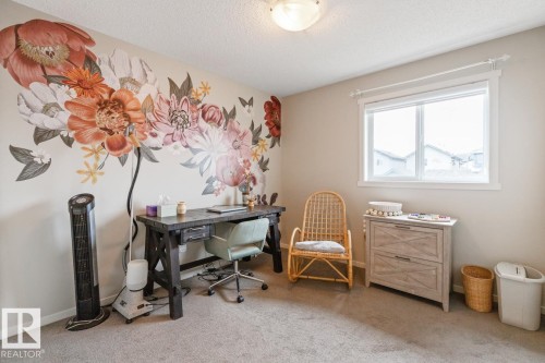 Neutral-toned room featuring a decorative floral wall mural - 5127 1A Avenue, Edmonton, AB - Indoor Photo Showing Other Room