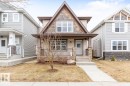 Two-story property featuring a prominent gable roofline with shake siding accents, horizontal siding, and stone veneer detailing - 5127 1A Avenue, Edmonton, AB  - Outdoor With Deck Patio Veranda With Facade 