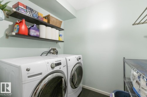 Dedicated laundry area with light green walls - 5127 1A Avenue, Edmonton, AB - Indoor Photo Showing Laundry Room