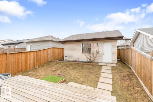 Detached utility building featuring vinyl siding and a shingled roof - 5127 1A Avenue, Edmonton, AB - Outdoor With Deck Patio Veranda With Exterior