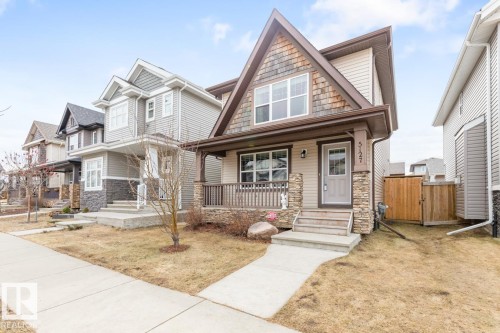 Contemporary two-story exterior with mixed siding, stone accents, and a prominent front gable - 5127 1A Avenue, Edmonton, AB - Outdoor With Deck Patio Veranda With Facade