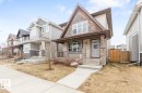 Contemporary two-story exterior with mixed siding, stone accents, and a prominent front gable - 5127 1A Avenue, Edmonton, AB  - Outdoor With Deck Patio Veranda With Facade 