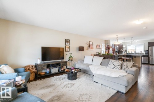 Open-concept living space featuring wood-finish flooring, neutral wall tones, and recessed lighting - 5127 1A Avenue, Edmonton, AB - Indoor Photo Showing Living Room