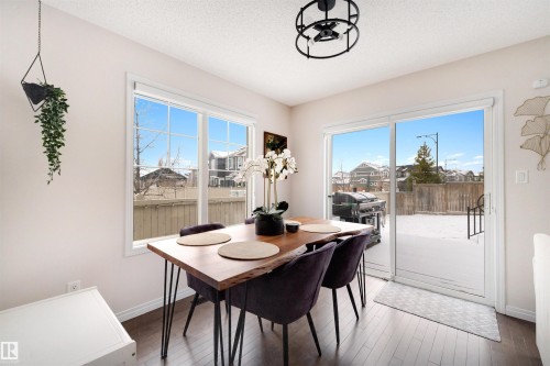 Bright dining area featuring dark wood-finish flooring - 2504 Coughlan Road, Edmonton, AB - Indoor Photo Showing Dining Room