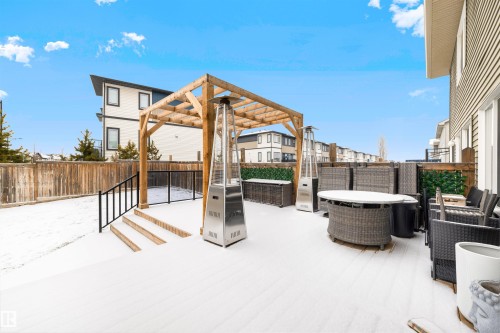 Spacious rear deck with a wood pergola, three-step wooden stairs, and black metal railing - 2504 Coughlan Road, Edmonton, AB - Outdoor