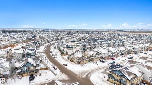 Aerial perspective showcasing a residential community with varied architectural styles, curved street layouts, and tree-lined streets - 2504 Coughlan Road, Edmonton, AB - Outdoor With View