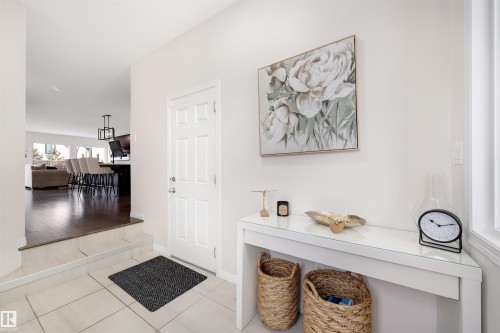Entryway featuring tile flooring, a paneled door, and a white console table - 2504 Coughlan Road, Edmonton, AB - Indoor Photo Showing Other Room