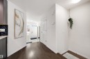 Inviting entryway featuring dark wood-finish flooring, white trim, a white entry door with frosted glass inserts, and a closet with a paneled door - 2504 Coughlan Road, Edmonton, AB  - Indoor Photo Showing Other Room 