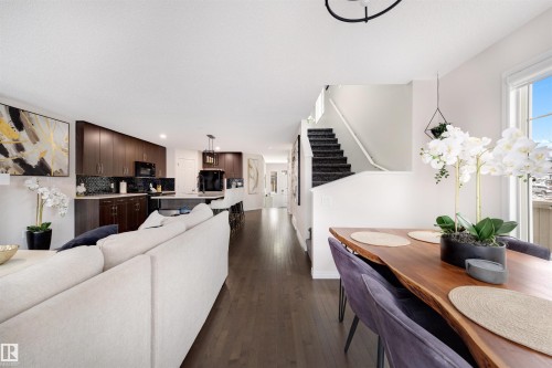 Open concept living area featuring dark wood-finish flooring - 2504 Coughlan Road, Edmonton, AB - Indoor