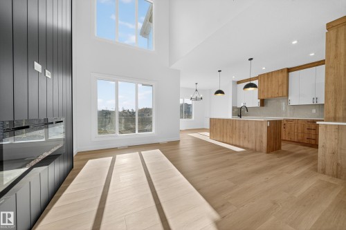 Open-concept living space with high ceilings and wood-finish flooring - 3285 Chernowski Way, Edmonton, AB - Indoor