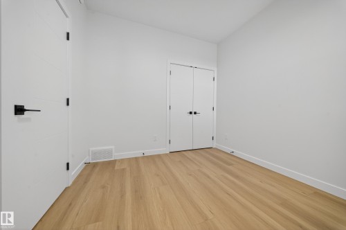 Room featuring light wood-finish flooring, white walls, and white baseboards - 3285 Chernowski Way, Edmonton, AB - Indoor Photo Showing Other Room
