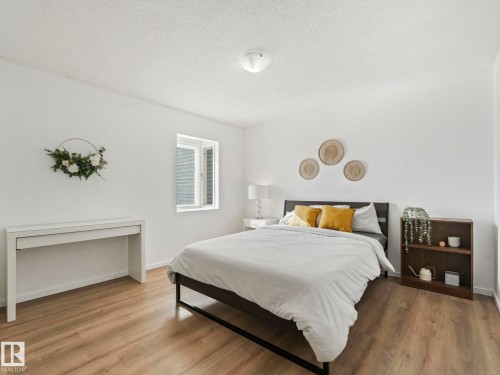 This room features light-toned flooring, white walls, and a window providing natural light - 12219 25 Avenue, Edmonton, AB - Indoor Photo Showing Bedroom