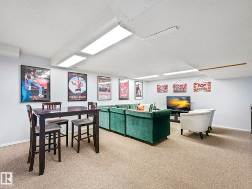 Recreational room featuring carpeted flooring, a light-colored ceiling with recessed lighting, and light-colored walls - 12219 25 Avenue, Edmonton, AB - Indoor