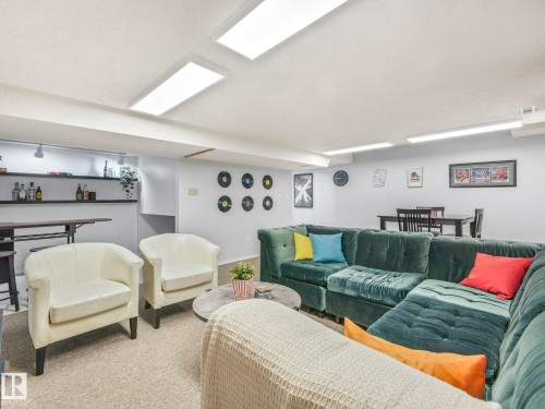 The property features a versatile open concept recreation room with recessed lighting, a built-in bar, and a dining area - 12219 25 Avenue, Edmonton, AB - Indoor