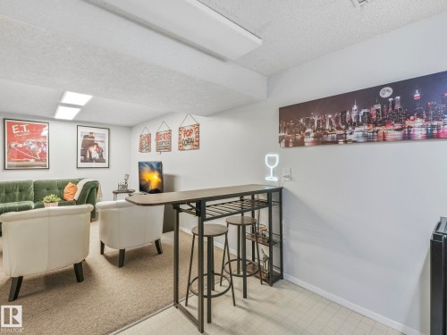 The property features a recreational space with light-colored walls and recessed lighting - 12219 25 Avenue, Edmonton, AB - Indoor Photo Showing Other Room