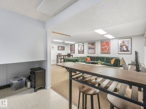 This space features light-colored walls and overhead lighting - 12219 25 Avenue, Edmonton, AB - Indoor Photo Showing Other Room