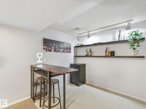 This space features light-colored walls and a track lighting system - 12219 25 Avenue, Edmonton, AB - Indoor Photo Showing Other Room