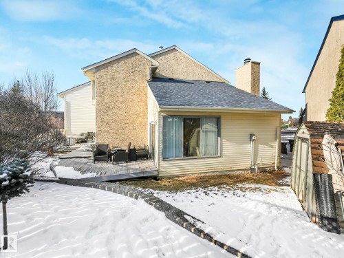 The property features a private deck with outdoor seating, a window, and a chimney - 12219 25 Avenue, Edmonton, AB - Outdoor