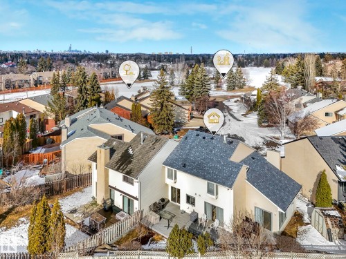 Aerial view of the property and surrounding neighborhood, featuring a large body of water, mature trees, and nearby properties - 12219 25 Avenue, Edmonton, AB - Outdoor