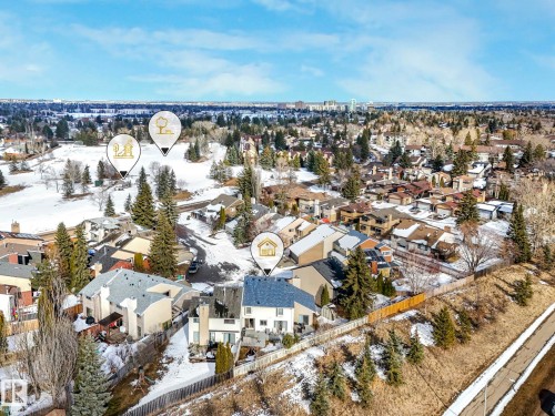Aerial view of the property and its surrounding area, featuring a blue roof and an elevated deck - 12219 25 Avenue, Edmonton, AB - Outdoor With View