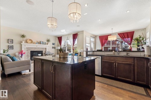 425 Simpkins Wynd, Leduc, AB - Indoor Photo Showing Kitchen With Fireplace