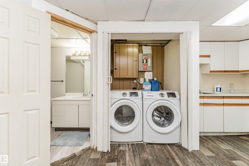 Dedicated laundry area featuring front-loading washer and dryer units - 10412 39 Avenue, Edmonton, AB - Indoor Photo Showing Laundry Room
