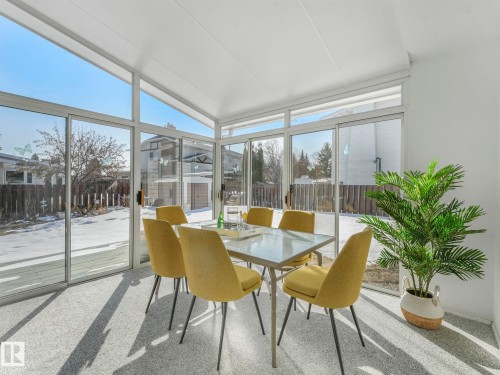 Sunroom featuring extensive glazing, a white ceiling, and light-colored flooring - 3421 112A Street, Edmonton, AB - 