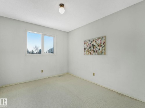 The room features a window providing natural light, light-colored carpeting, and a ceiling-mounted light fixture - 3421 112A Street, Edmonton, AB - Indoor Photo Showing Other Room