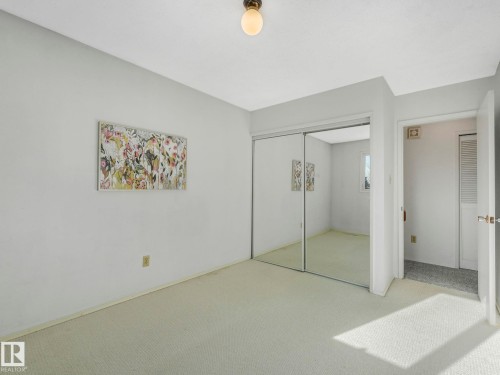 The room features light-colored carpeting, light gray walls, and a ceiling light fixture - 3421 112A Street, Edmonton, AB - Indoor Photo Showing Other Room