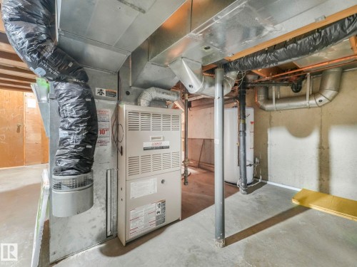 The property features a Lennox furnace, a water heater, and extensive ductwork, all situated on a concrete floor - 3421 112A Street, Edmonton, AB - Indoor Photo Showing Basement