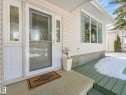 The property features a front entrance with a decorative glass insert door and sidelights, complemented by a large window - 3421 112A Street, Edmonton, AB  - Outdoor With Deck Patio Veranda With Exterior 