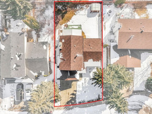 Aerial view of the property, showcasing its brown shingle roof, a paved driveway, and established trees on the lot - 3421 112A Street, Edmonton, AB - Outdoor