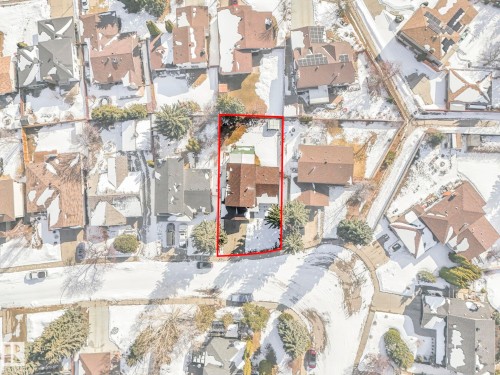 Aerial view of the property, outlined in red, situated within a residential neighborhood with a street visible in the foreground - 3421 112A Street, Edmonton, AB - Outdoor With View