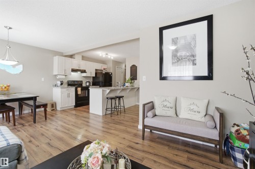 The property features an open-concept living area with light wood-style flooring and light-toned walls - 13905 138 St, Edmonton, AB - Indoor