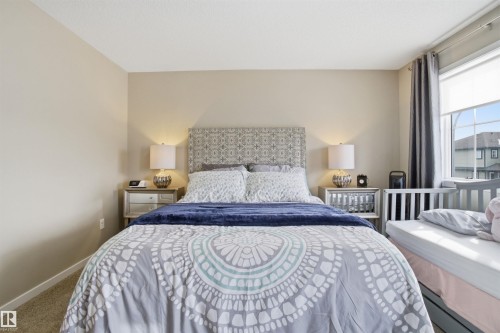 This room features neutral-toned walls, carpeting, and a window with blinds and drapes - 13905 138 St, Edmonton, AB - Indoor Photo Showing Bedroom
