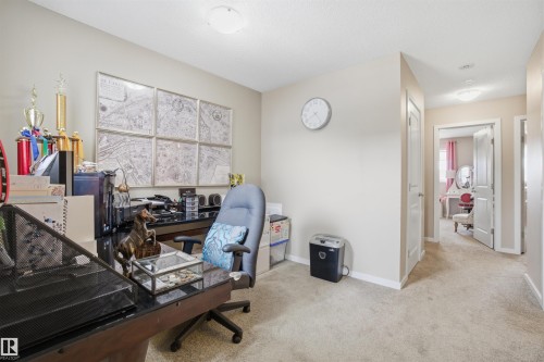 This versatile room features carpeted flooring and neutral wall tones, offering a comfortable and adaptable space - 13905 138 St, Edmonton, AB - Indoor Photo Showing Other Room