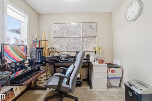 This versatile room features carpeted flooring, a window providing natural light, and a dedicated desk area - 13905 138 St, Edmonton, AB - Indoor Photo Showing Office