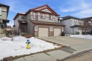 The property features a two-story exterior with grey siding and red trim, complemented by stone accents - 13905 138 St, Edmonton, AB  - Outdoor With Facade 