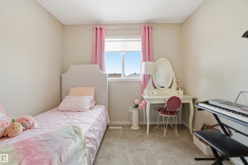 This room features light-colored walls and grey carpet, with a window providing natural light - 13905 138 St, Edmonton, AB - Indoor Photo Showing Bedroom
