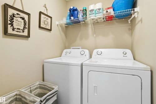 Laundry area featuring a washer and dryer, along with a wire shelf for storage - 13905 138 St, Edmonton, AB - Indoor Photo Showing Laundry Room