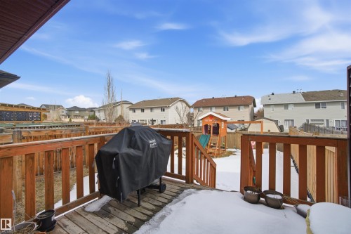 The property features a wooden deck with a protective railing, providing outdoor access - 13905 138 St, Edmonton, AB - Outdoor With Deck Patio Veranda With Exterior