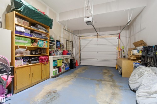 The property features an attached garage with a powered garage door and a painted concrete floor - 13905 138 St, Edmonton, AB - Indoor Photo Showing Garage