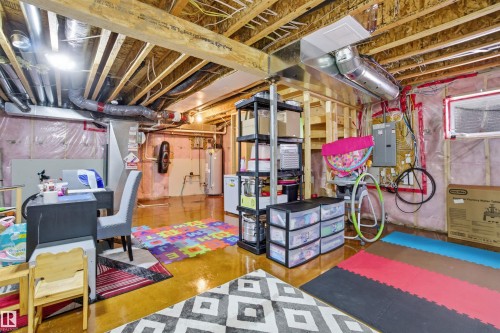 The property includes a substantial unfinished basement with exposed wooden joists and ductwork - 13905 138 St, Edmonton, AB - Indoor Photo Showing Basement