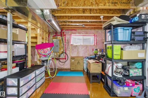 The property offers an unfinished basement with exposed wooden joists and ductwork, providing potential for customization - 13905 138 St, Edmonton, AB - Indoor Photo Showing Other Room