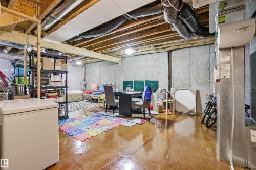 This spacious unfinished basement offers concrete walls and exposed ceiling beams - 13905 138 St, Edmonton, AB - Indoor Photo Showing Basement