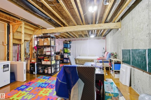 The property features an unfinished basement with exposed wooden joists and concrete walls, offering potential for future development - 13905 138 St, Edmonton, AB - Indoor Photo Showing Basement